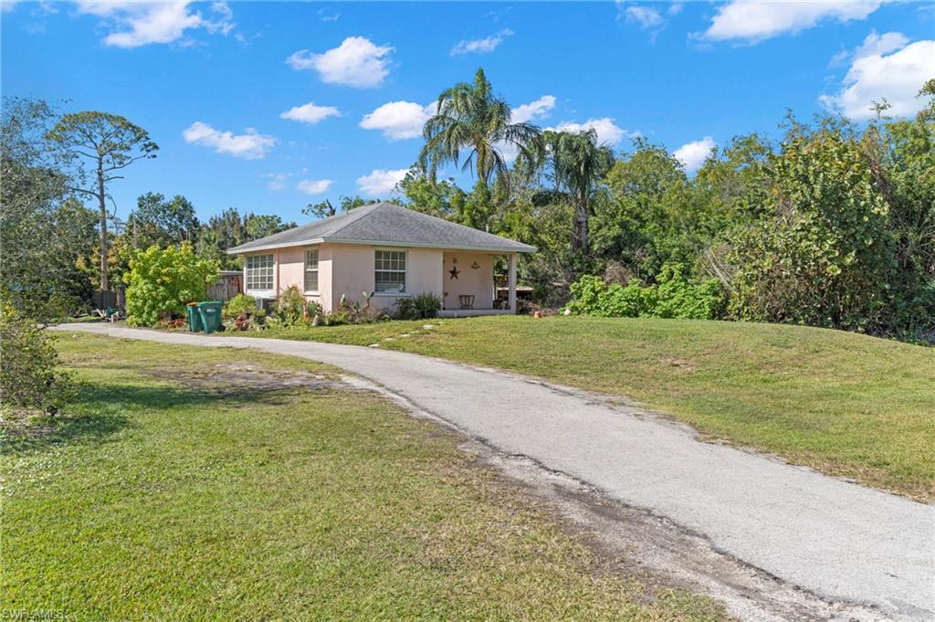 851 Barefoot Williams Road Naples, FL 34113 - Photo 25 of 35 a house view with a garden space