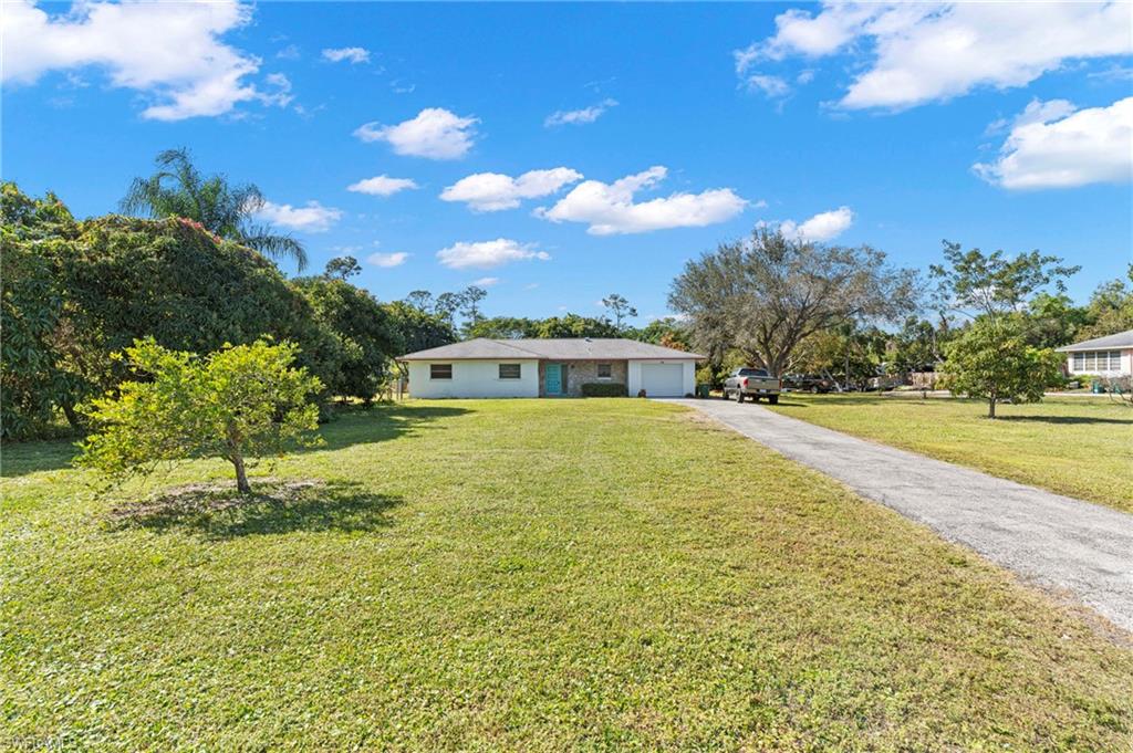 851 Barefoot Williams Road Naples, FL 34113 - Photo 5 of 35 a swimming pool with trees in the background