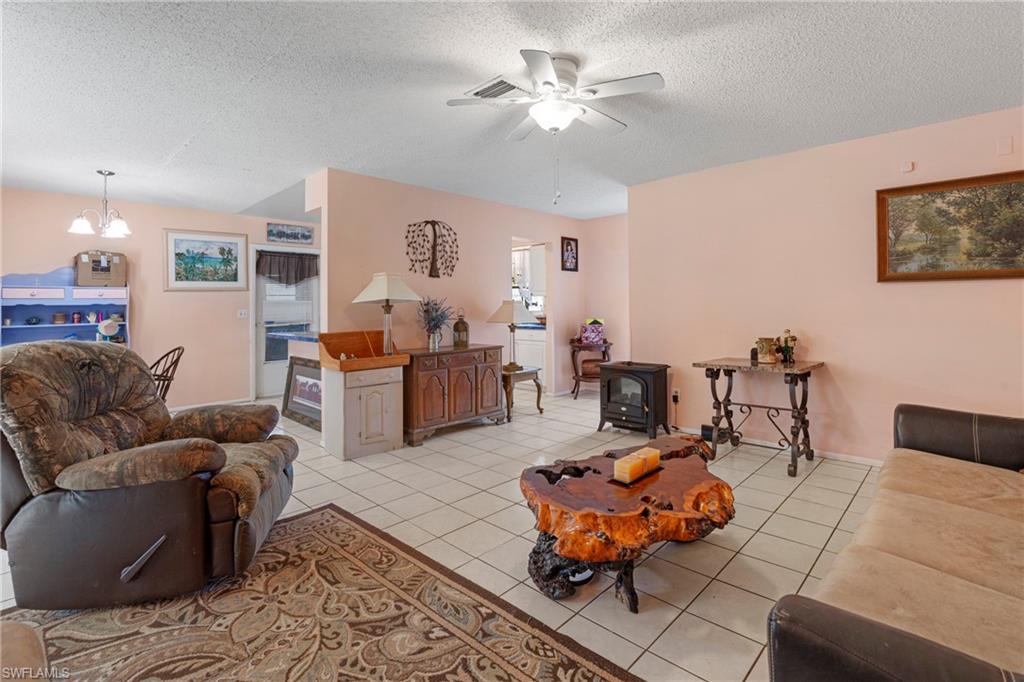 851 Barefoot Williams Road Naples, FL 34113 - Photo 10 of 35 a living room with furniture and a chandelier