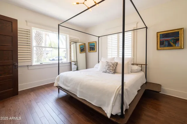 a bedroom with a bed and a flat screen tv