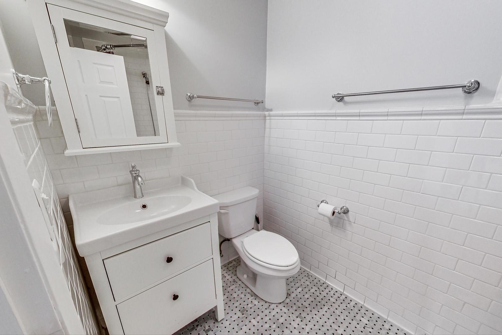 3510 East Frontage Road Rolling Meadows, IL 60008 - Photo 12 of 27 a bathroom with a toilet sink and mirror