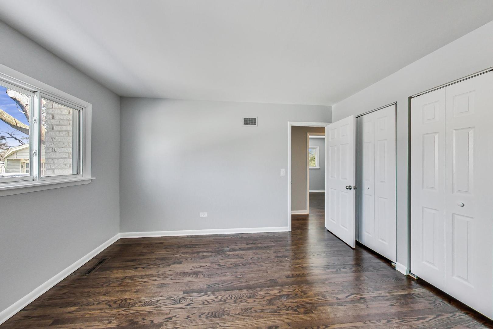 3510 East Frontage Road Rolling Meadows, IL 60008 - Photo 16 of 27 a view of an empty room with wooden floor and a window