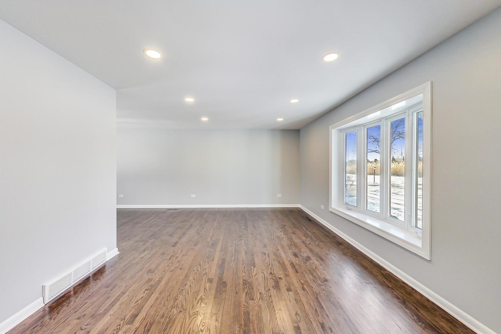 3510 East Frontage Road Rolling Meadows, IL 60008 - Photo 3 of 27 a view of an empty room with wooden floor and a window