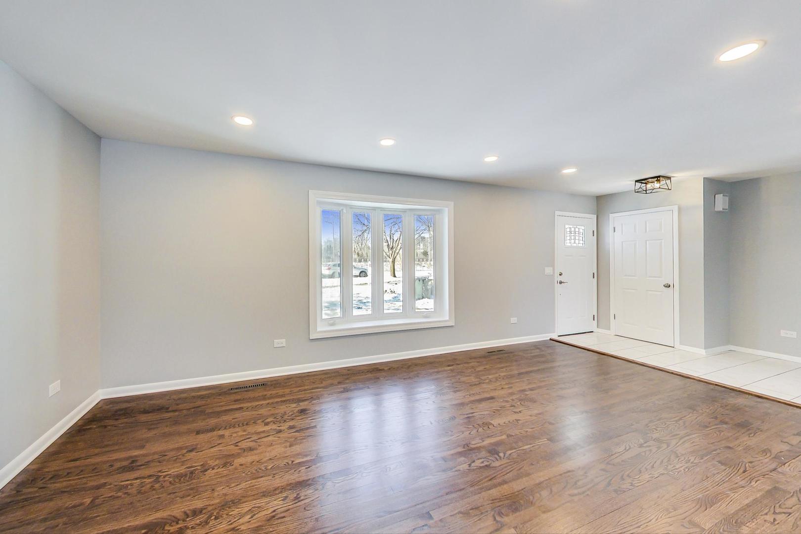 3510 East Frontage Road Rolling Meadows, IL 60008 - Photo 4 of 27 a view of an empty room with wooden floor and a window