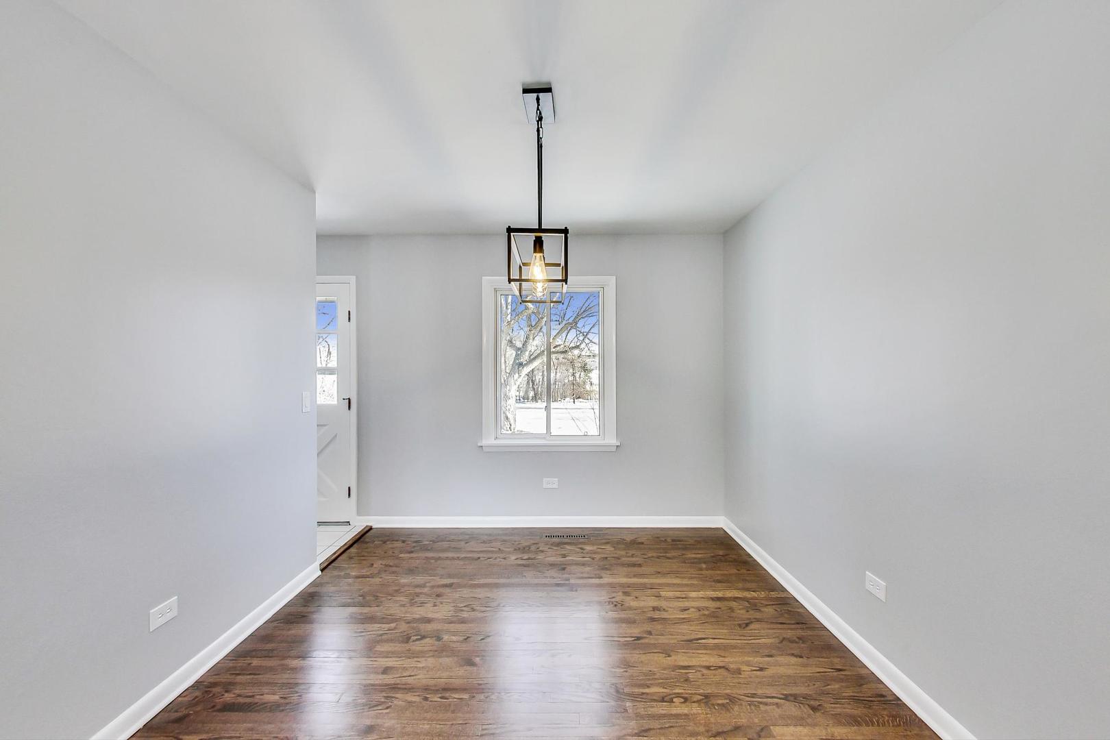 3510 East Frontage Road Rolling Meadows, IL 60008 - Photo 6 of 27 a view of empty room with wooden floor and window