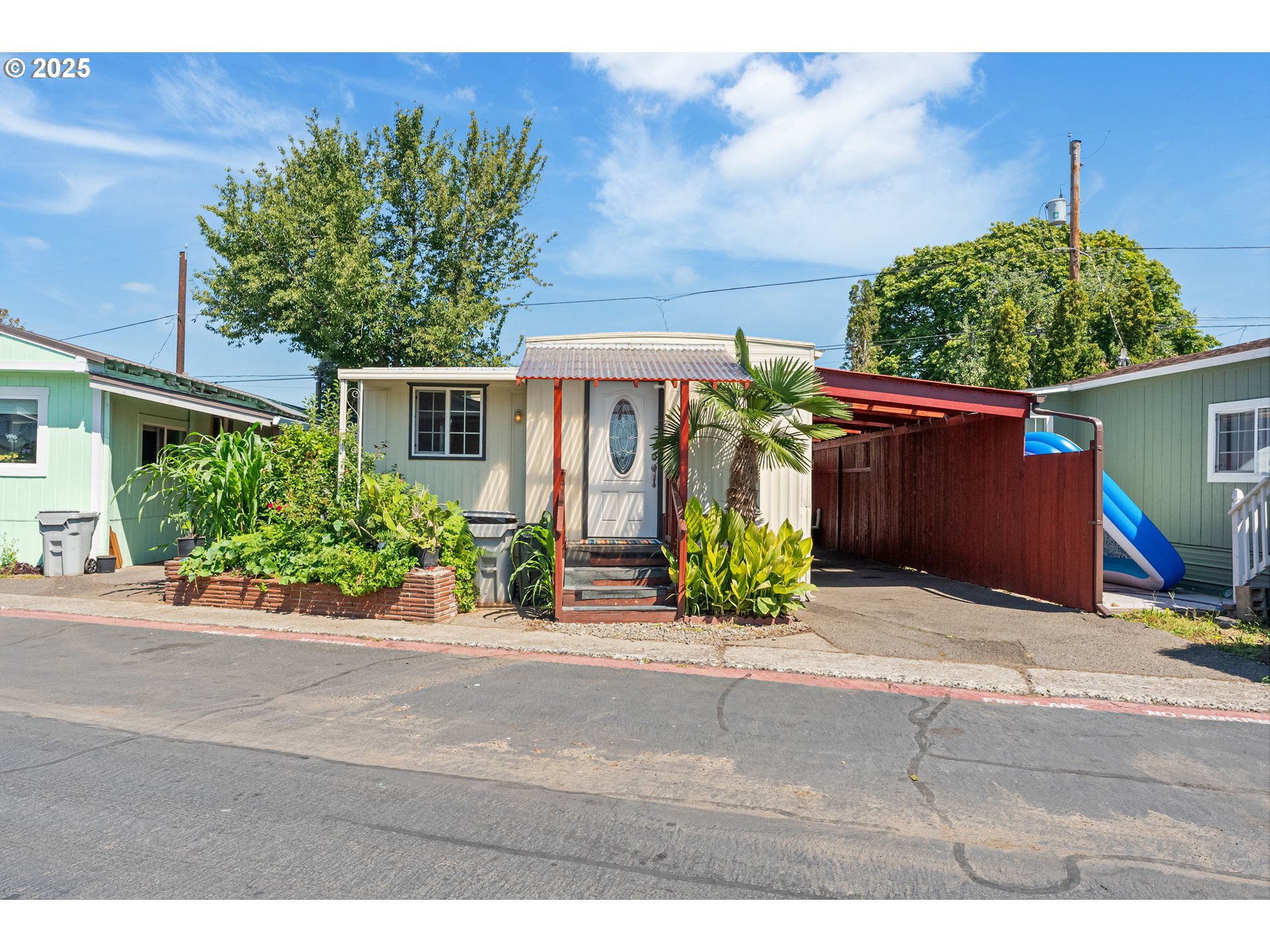 8951 Southeast Fuller Road, Unit 7 Happy Valley, OR 97086 - Photo 1 of 29 a front view of a house with garden