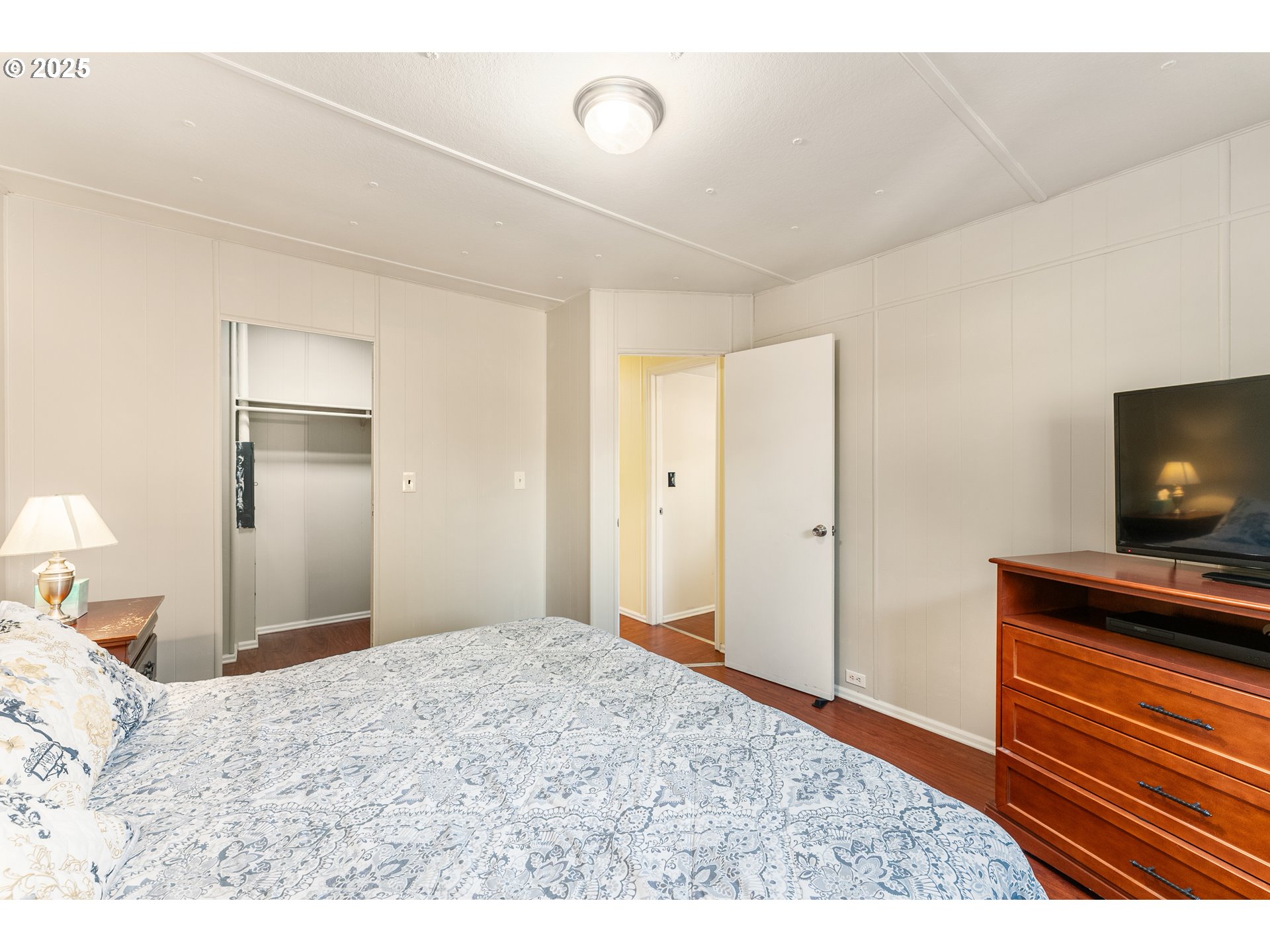 8951 Southeast Fuller Road, Unit 7 Happy Valley, OR 97086 - Photo 11 of 29 a bedroom with a bed and a flat screen tv