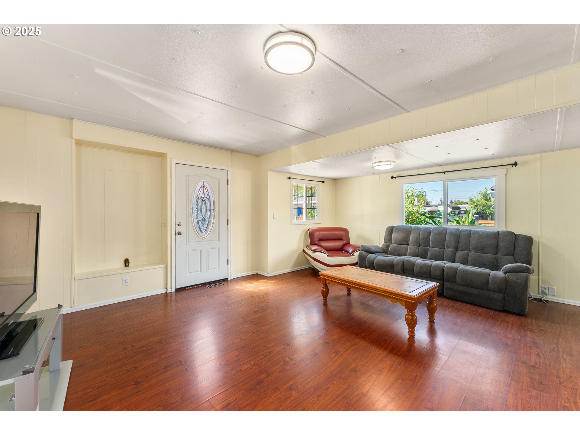 8951 Southeast Fuller Road, Unit 7 Happy Valley, OR 97086 - Photo 3 of 29 a living room with furniture and a wooden floor