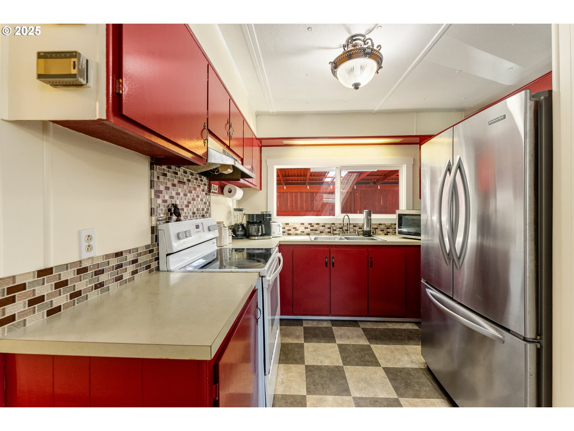 8951 Southeast Fuller Road, Unit 7 Happy Valley, OR 97086 - Photo 7 of 29 a kitchen with stainless steel appliances granite countertop a refrigerator a sink and a stove