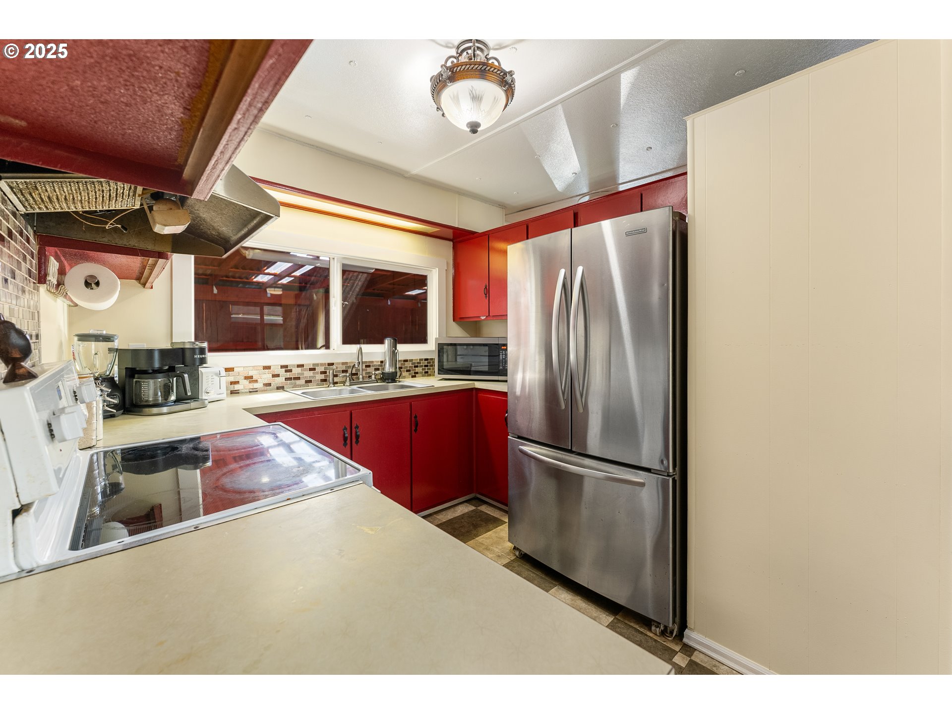 8951 Southeast Fuller Road, Unit 7 Happy Valley, OR 97086 - Photo 8 of 29 a kitchen with stainless steel appliances granite countertop a refrigerator a stove and a sink with wooden floor