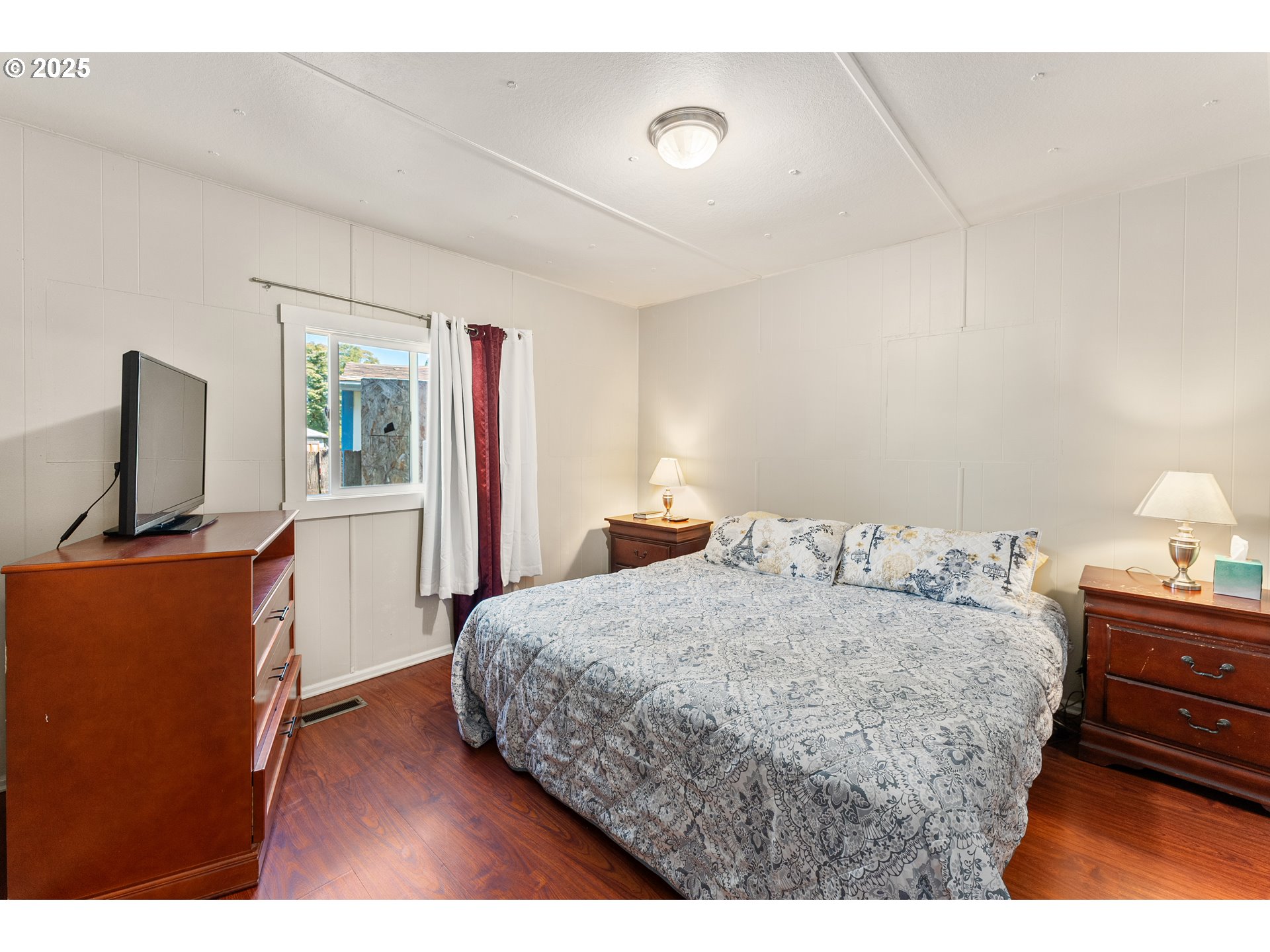 8951 Southeast Fuller Road, Unit 7 Happy Valley, OR 97086 - Photo 10 of 29 a bedroom with a bed and flat screen tv