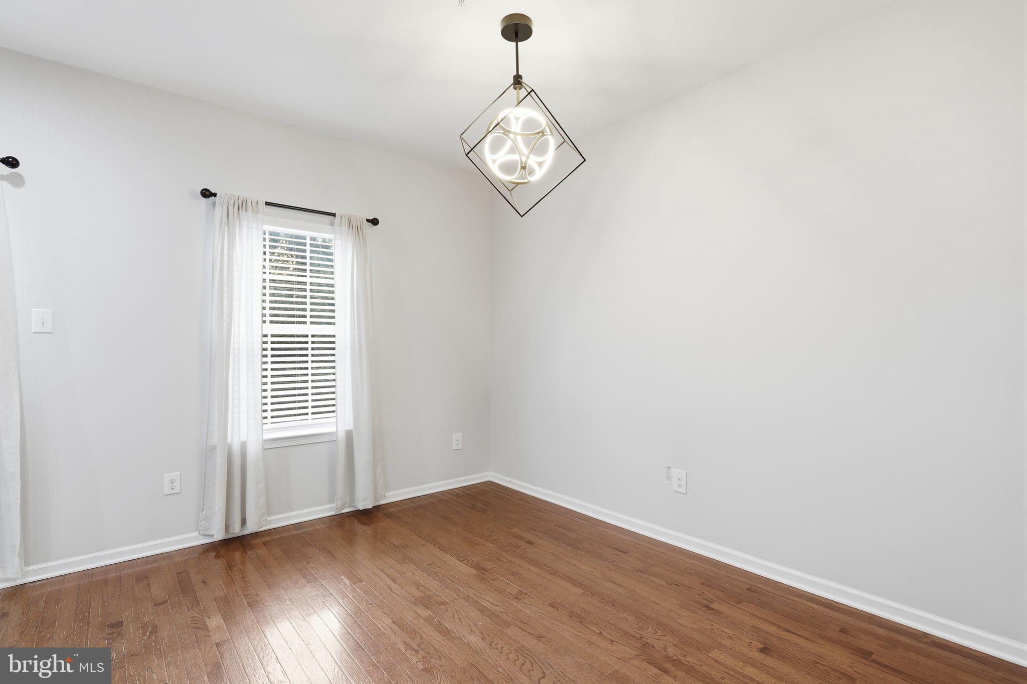 3832 William Daves Road, Unit 3 Doylestown, PA 18902 - Photo 12 of 35 a view of an empty room with a window and wooden floor
