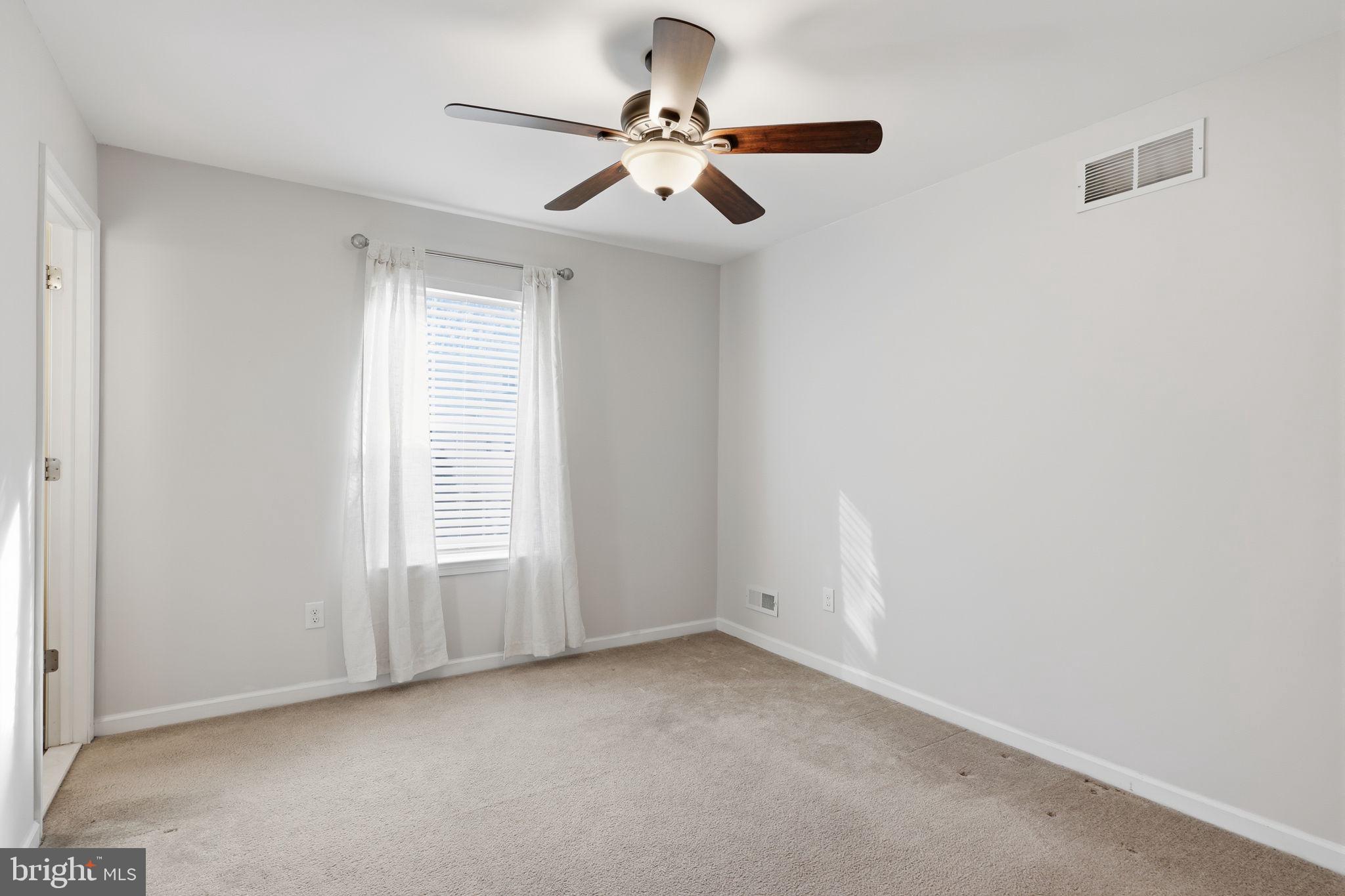 3832 William Daves Road, Unit 3 Doylestown, PA 18902 - Photo 19 of 35 an empty room with windows and fan