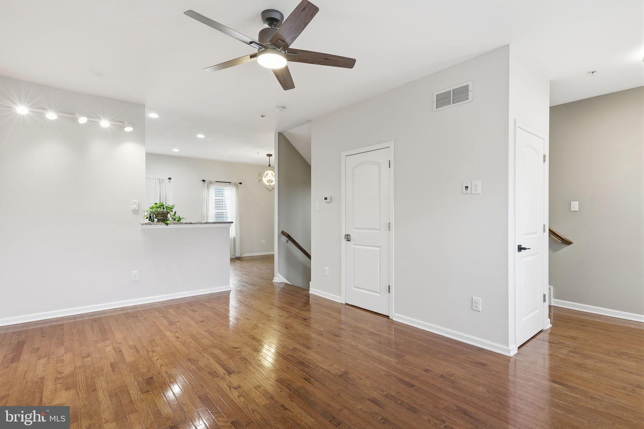 3832 William Daves Road, Unit 3 Doylestown, PA 18902 - Photo 4 of 35 a view of a hallway with wooden floor and a kitchen