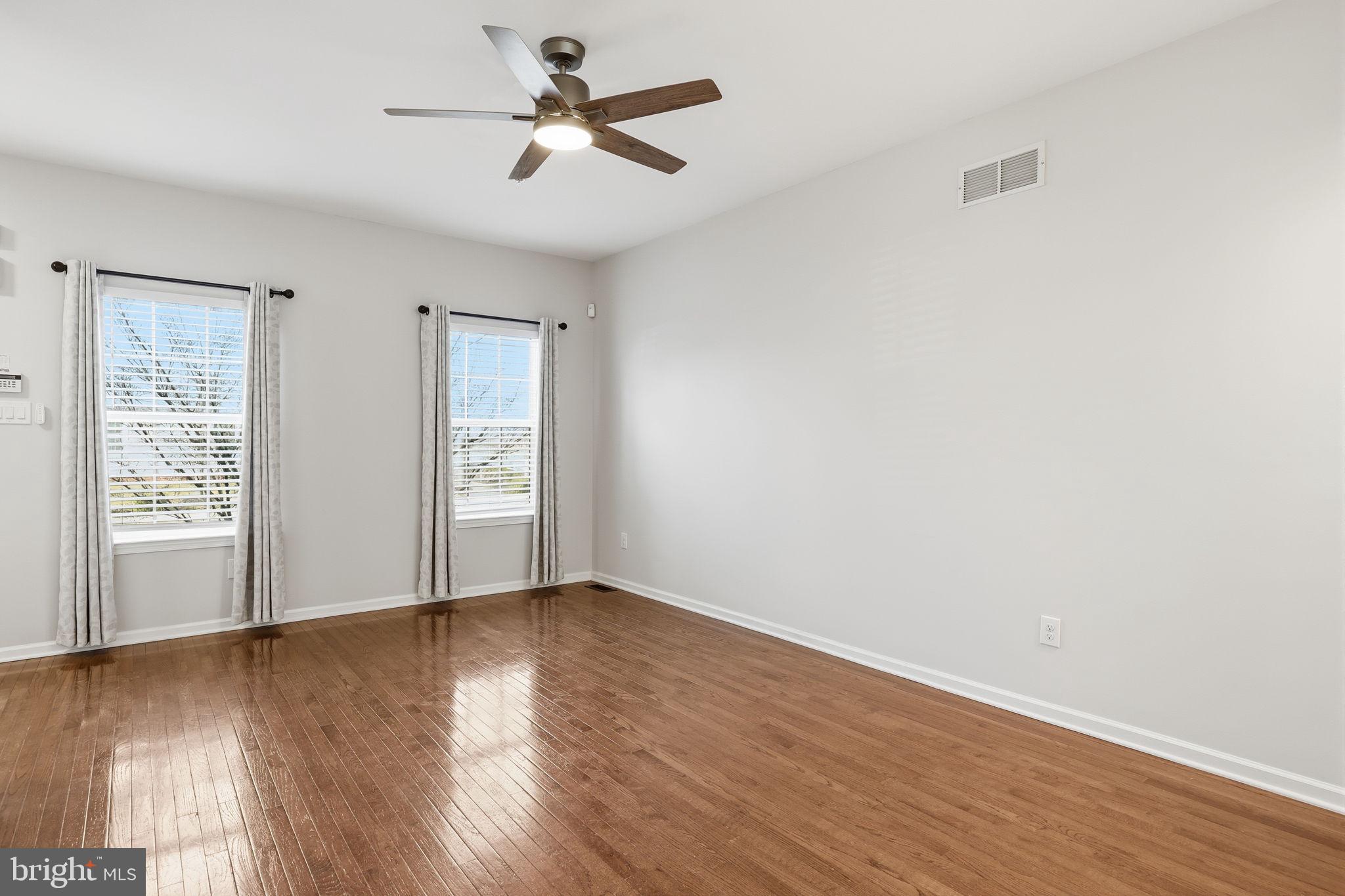 3832 William Daves Road, Unit 3 Doylestown, PA 18902 - Photo 7 of 35 a view of an empty room with wooden floor and a window
