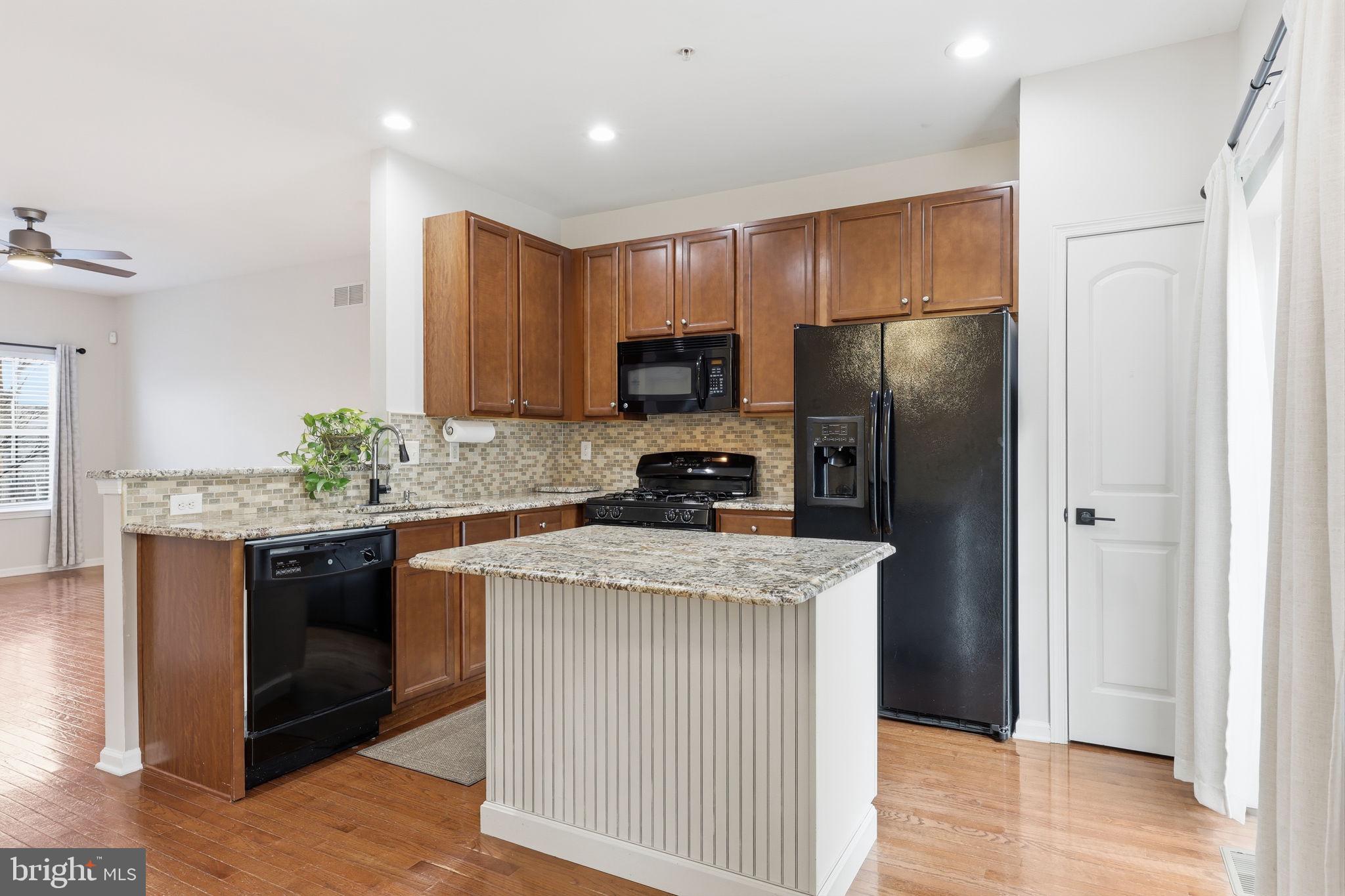 3832 William Daves Road, Unit 3 Doylestown, PA 18902 - Photo 8 of 35 a kitchen with granite countertop a refrigerator stove and oven