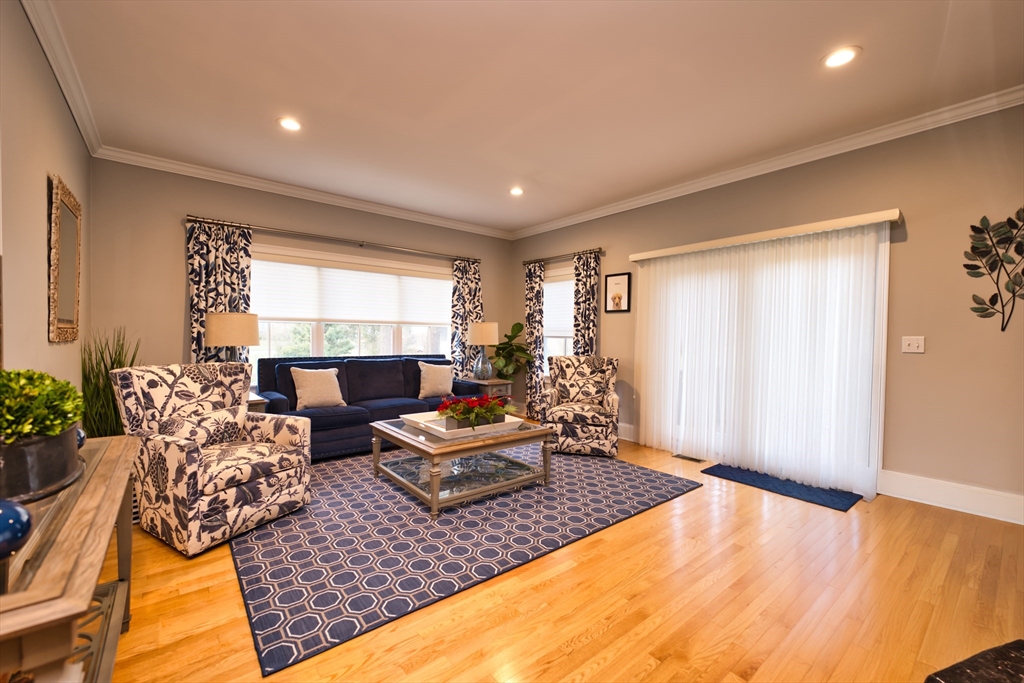 8 Hathaway Pond Circle, Unit 8 Rochester, MA 02770 - Photo 11 of 24 a living room with furniture and a large window