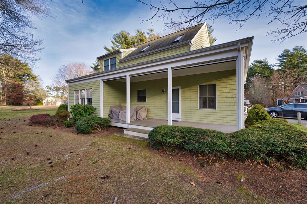 8 Hathaway Pond Circle, Unit 8 Rochester, MA 02770 - Photo 4 of 24 a view of a house with a small yard plants and large tree