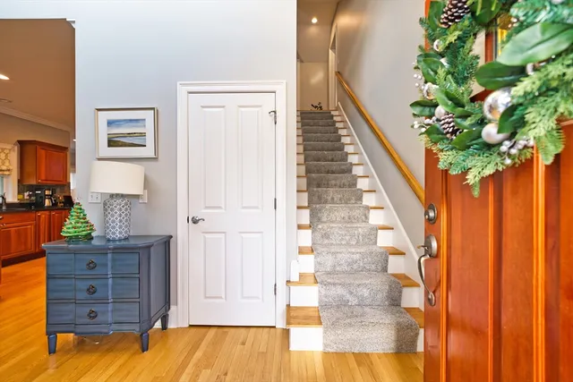 a view of a hallway with wooden floor and entryway