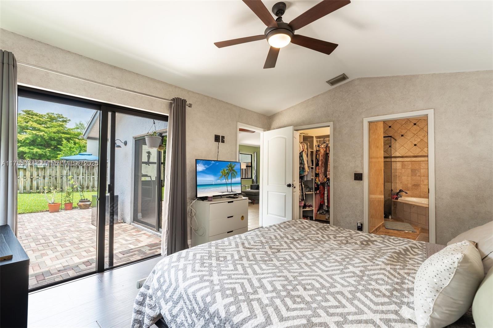 563 Lakeside Circle Sunrise, FL 33326 - Photo 12 of 36 a bedroom with a bed and a large mirror