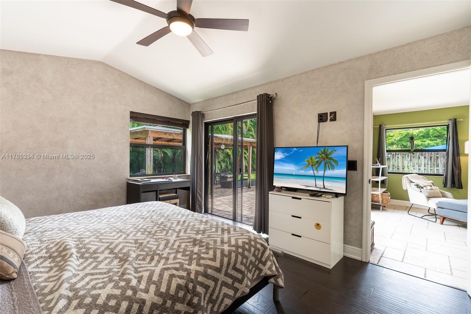 563 Lakeside Circle Sunrise, FL 33326 - Photo 14 of 36 a bedroom with a bed and a flat tv screen on dresser