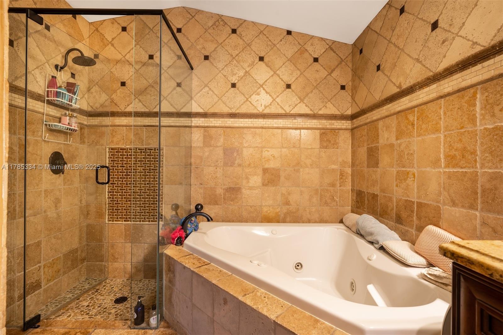 563 Lakeside Circle Sunrise, FL 33326 - Photo 17 of 36 a bathroom with a bathtub and shower