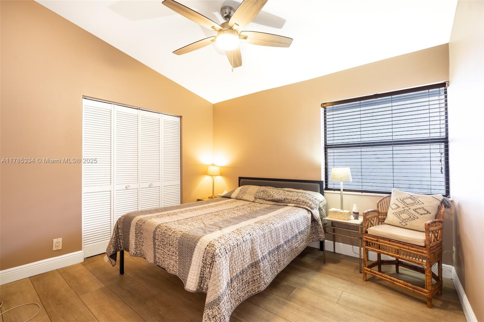 563 Lakeside Circle Sunrise, FL 33326 - Photo 18 of 36 a bedroom with a bed and a chandelier