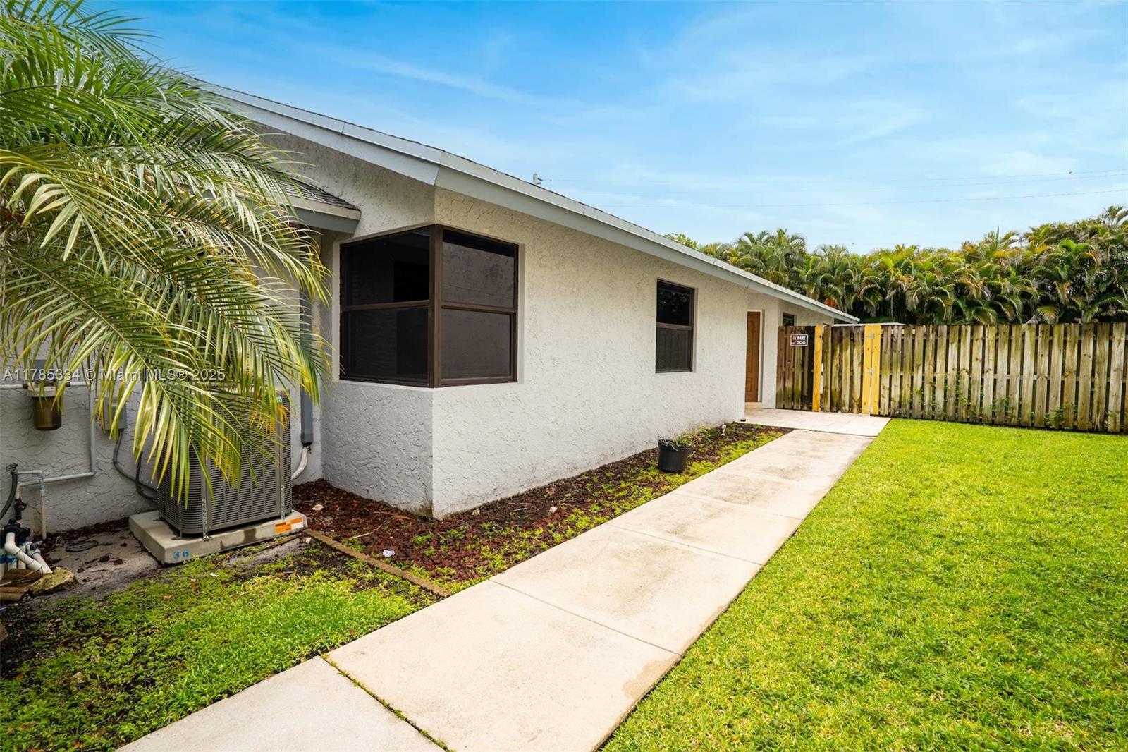 563 Lakeside Circle Sunrise, FL 33326 - Photo 2 of 36 a front view of a house with garden