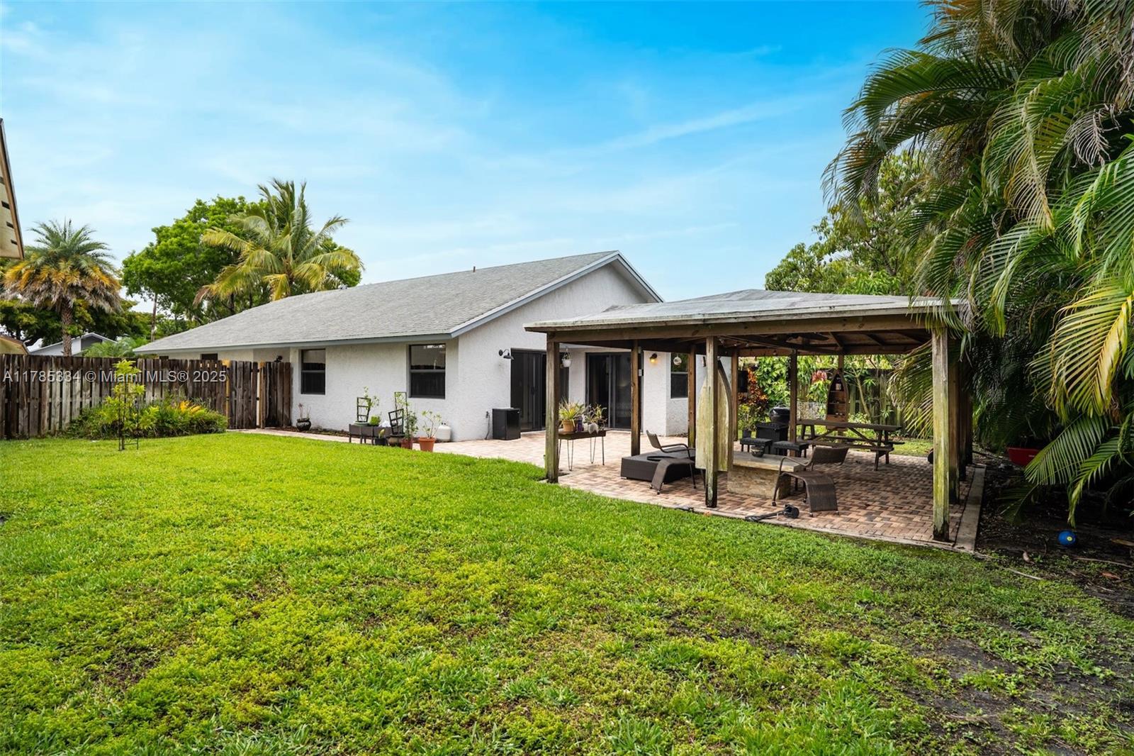 563 Lakeside Circle Sunrise, FL 33326 - Photo 24 of 36 a front view of a house with garden and porch