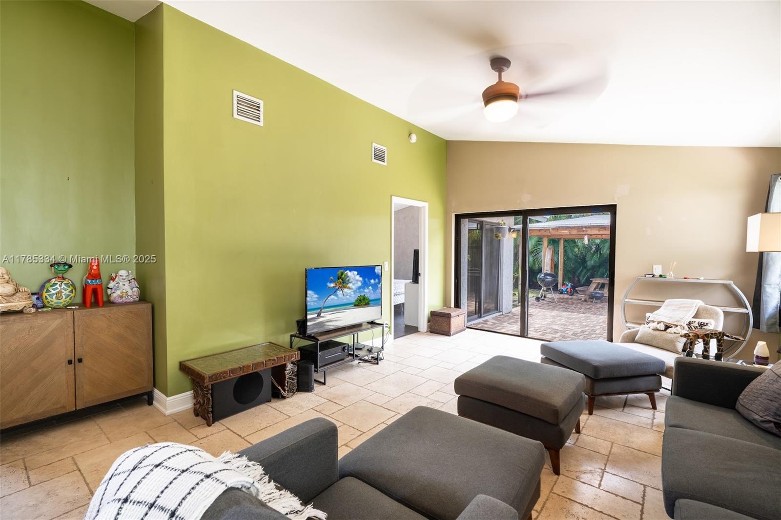 563 Lakeside Circle Sunrise, FL 33326 - Photo 5 of 36 a living room with furniture and a flat screen tv