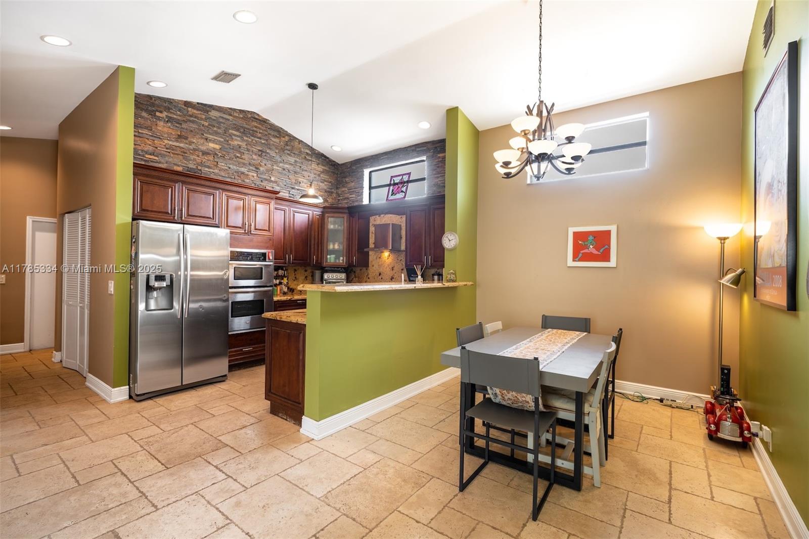 563 Lakeside Circle Sunrise, FL 33326 - Photo 7 of 36 a kitchen with stainless steel appliances kitchen island granite countertop a refrigerator and a sink