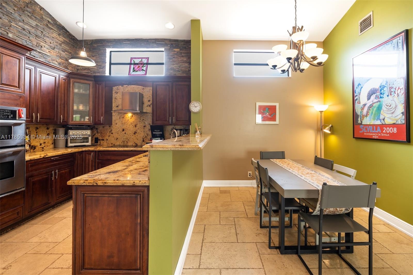 563 Lakeside Circle Sunrise, FL 33326 - Photo 8 of 36 a kitchen with a table and chairs in it