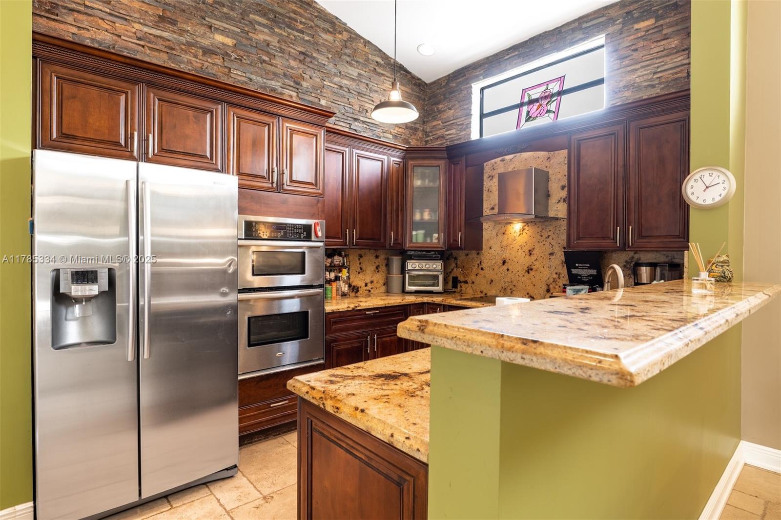 563 Lakeside Circle Sunrise, FL 33326 - Photo 9 of 36 a kitchen with kitchen island a counter top space cabinets and stainless steel appliances