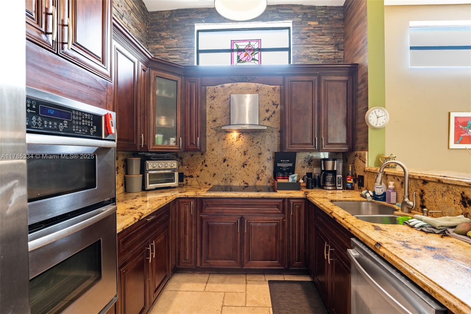 563 Lakeside Circle Sunrise, FL 33326 - Photo 10 of 36 a kitchen with stainless steel appliances granite countertop a stove and a sink