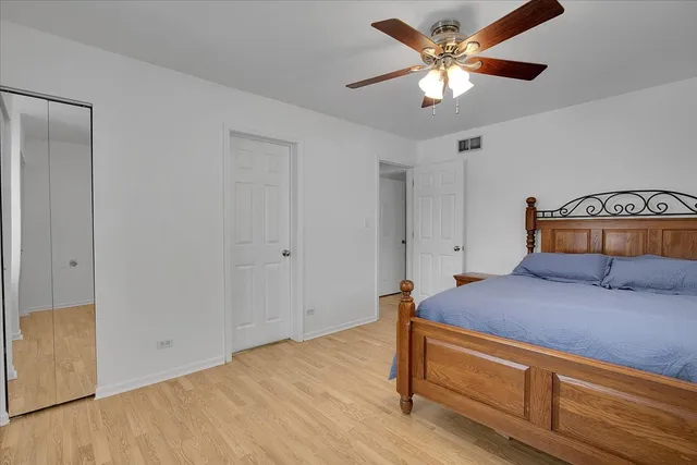 a bedroom with a bed and a ceiling fan