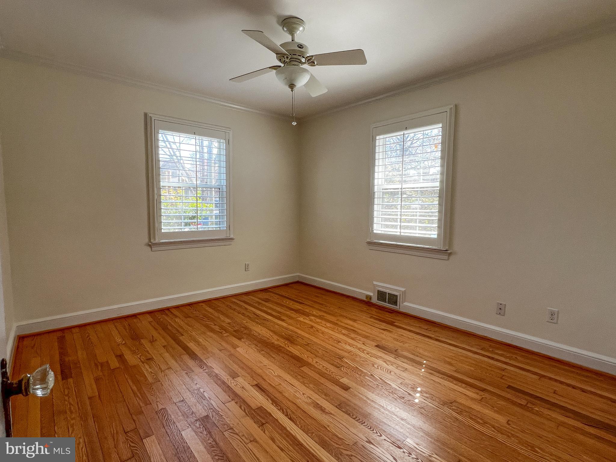 314 Hillmoor Drive Silver Spring, MD 20901 - Photo 12 of 24 a view of an empty room with a window and wooden floor