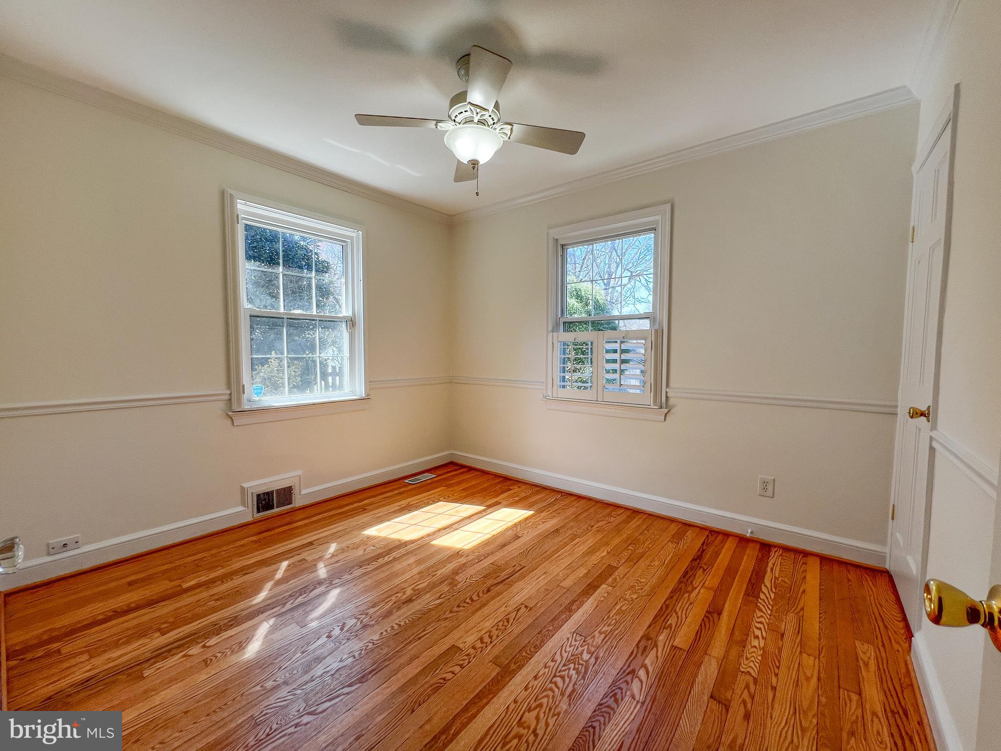 314 Hillmoor Drive Silver Spring, MD 20901 - Photo 14 of 24 a view of an empty room with wooden floor and a window