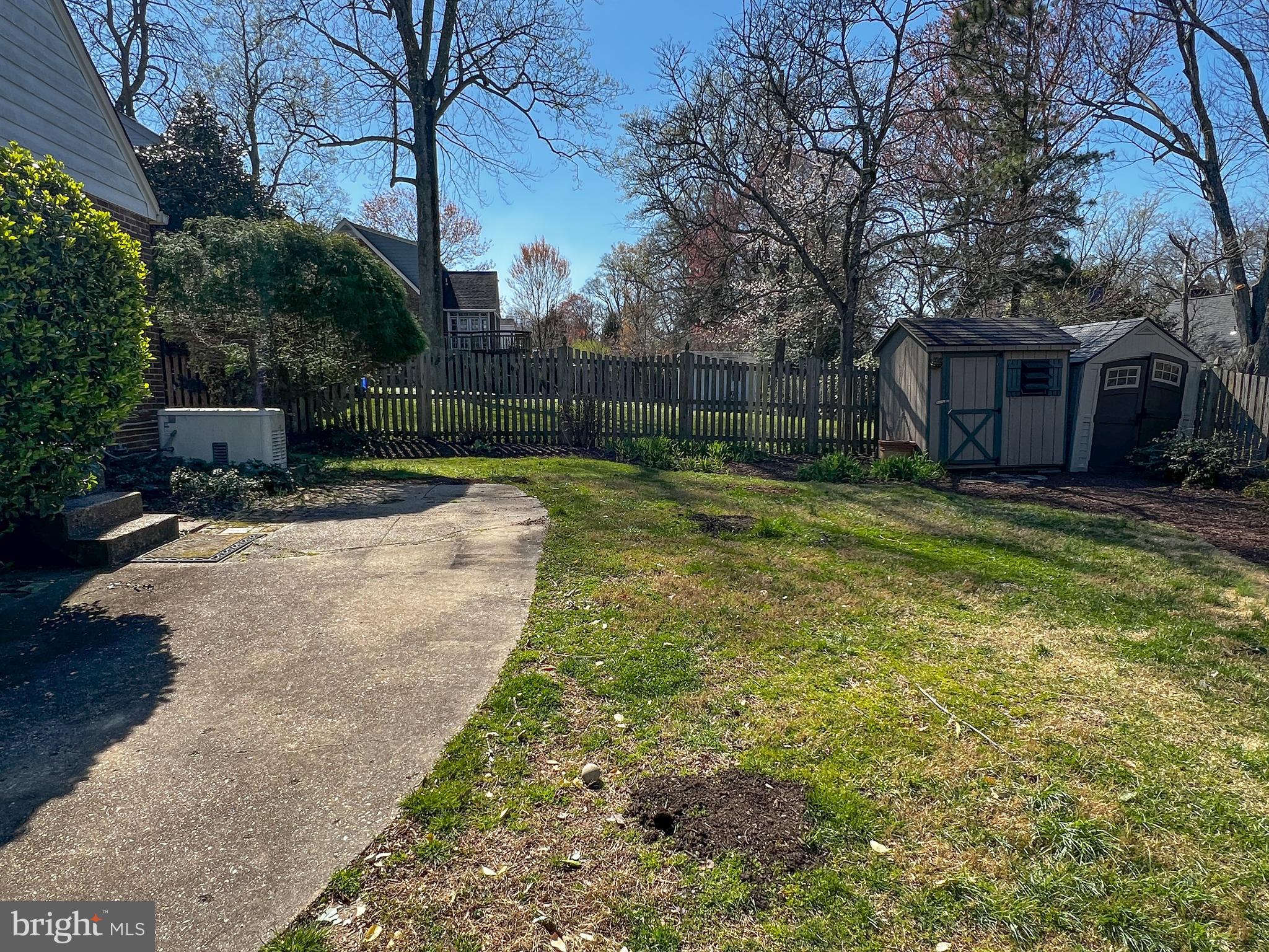 314 Hillmoor Drive Silver Spring, MD 20901 - Photo 23 of 24 a view of a backyard with a table and chair under an umbrella