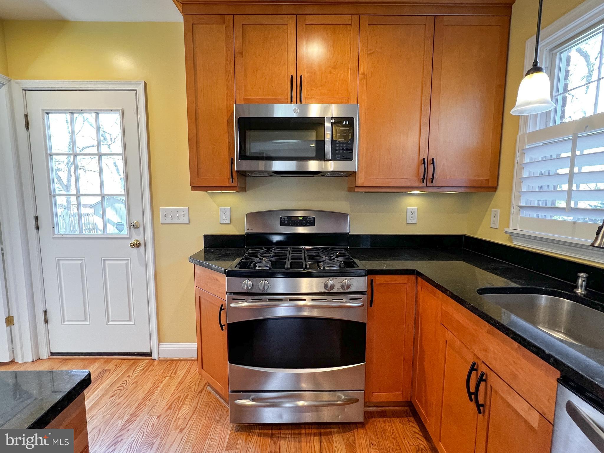 314 Hillmoor Drive Silver Spring, MD 20901 - Photo 9 of 24 a kitchen with granite countertop a stove and a sink