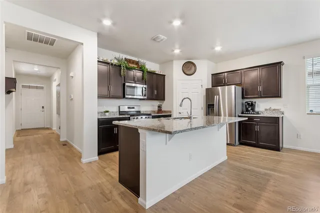 a kitchen with stainless steel appliances a refrigerator stove and microwave