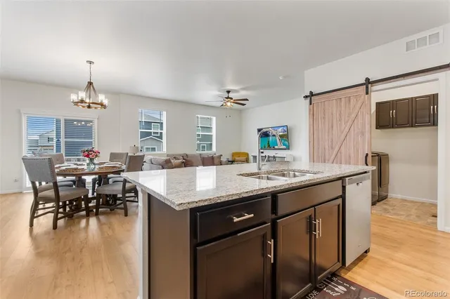 a kitchen with center island table and chairs