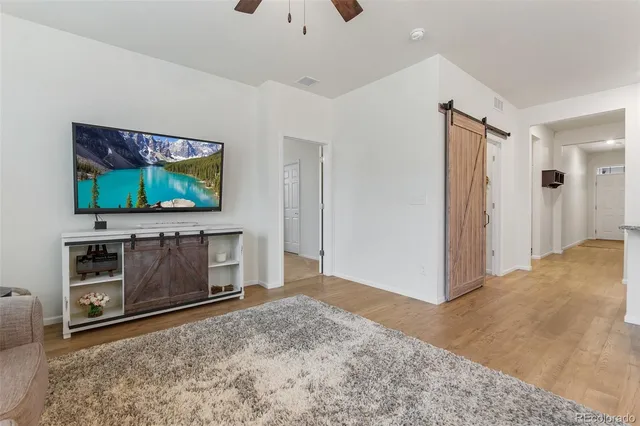 a living room with a flat screen tv and a fireplace