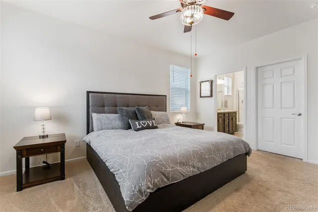 a bedroom with a bed and a table