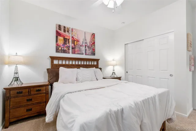 a bedroom with a bed and a painting on the wall