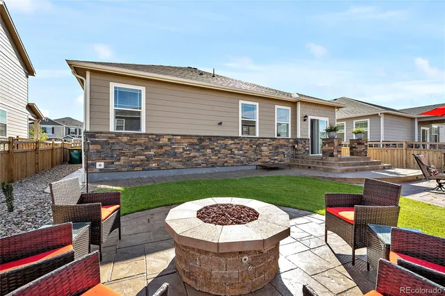 a view of a backyard with sitting area