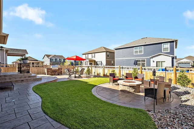 a view of a house with swimming pool and sitting area