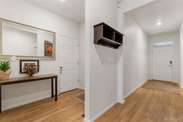 a view of hallway with wooden floor and stairs