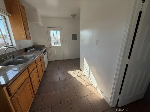 a view of a kitchen from the corridor