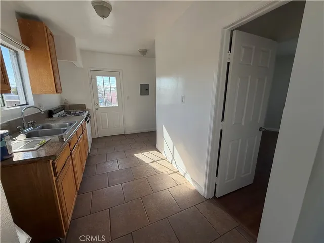a view of a small space with wooden floor and a window