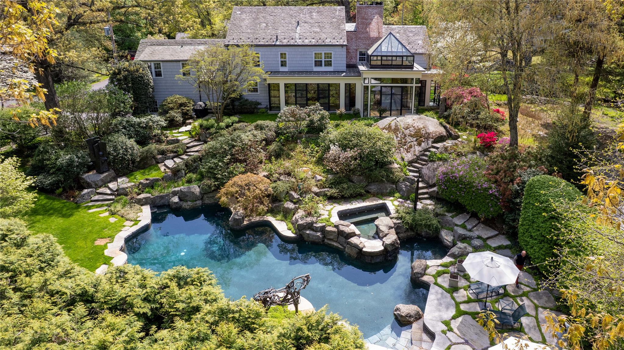 a aerial view of a house with a yard and garden